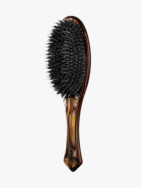 Oribe Italian Resin Flat Brush on multicolored branded component on a light gray background